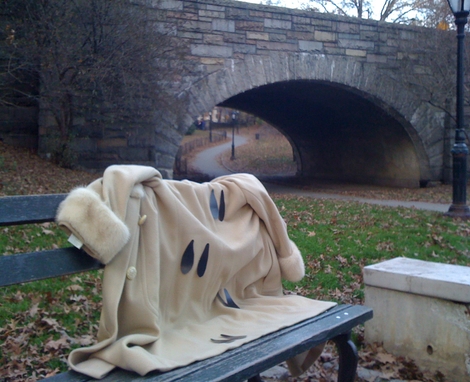 Coat with reindeer hooves on bench near stone bridge